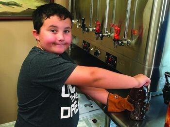 Tea-grand boy helping da Brewmaster brew sum a dat CajunTyme Ice Tea - He can't wait to drink it all up!